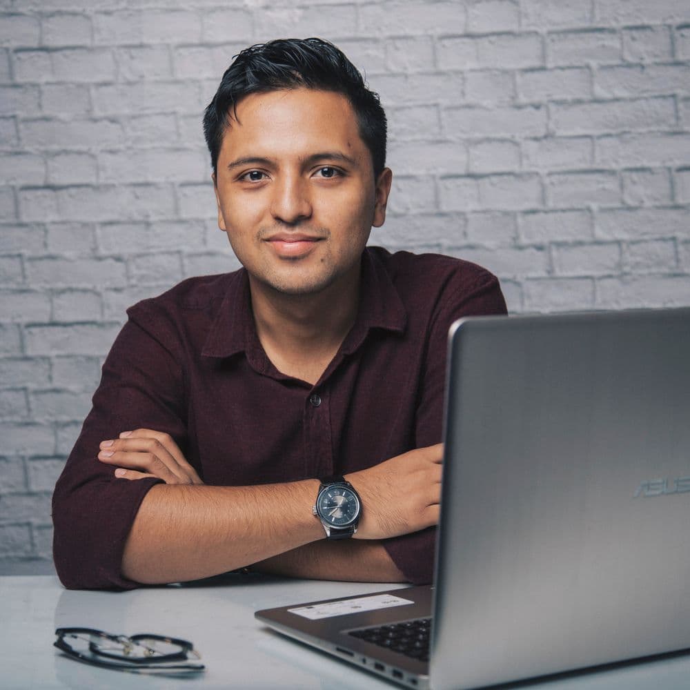 A member of the LeadMighty team at his laptop