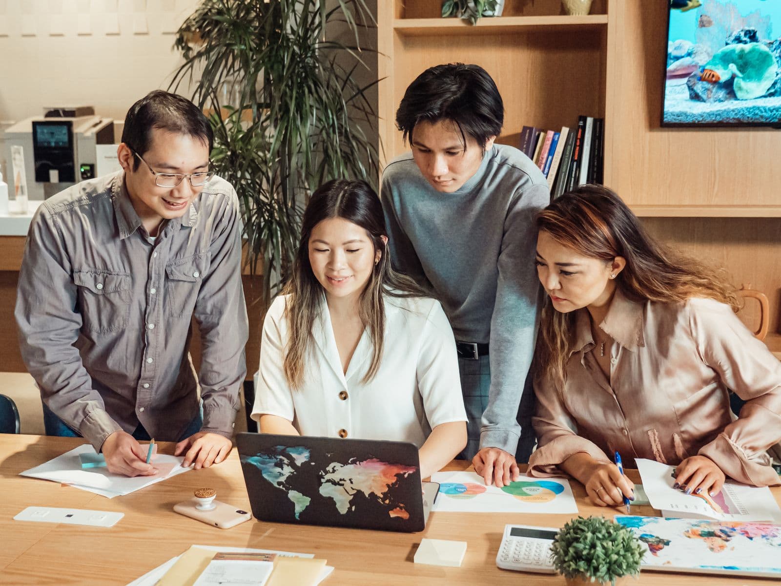 The LeadMighty team around a laptop